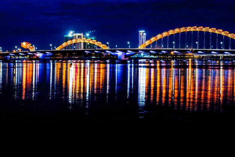 this is a night scene of a bridge spanning the water