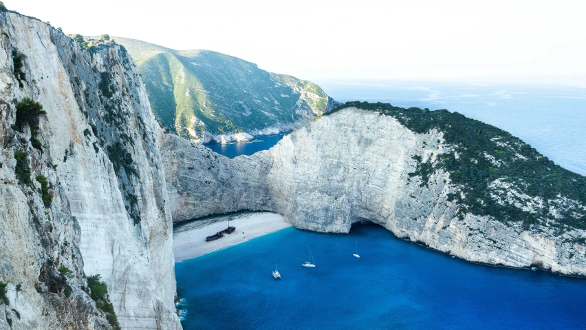 a cliff is shown in the middle of a large body of water