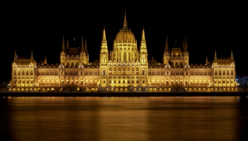 a large castle that has lit up at night