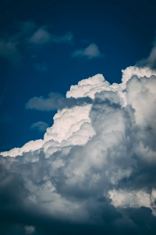 several clouds float in the blue sky above