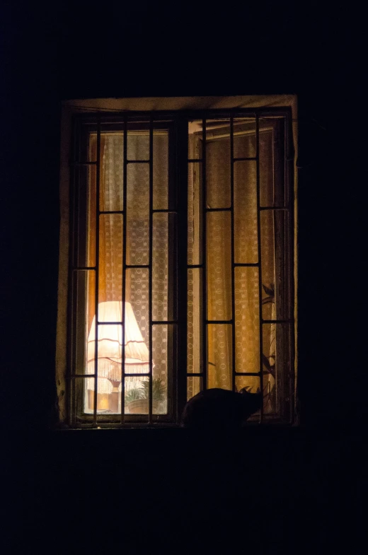 a dark room with a window that shows a light coming in from behind