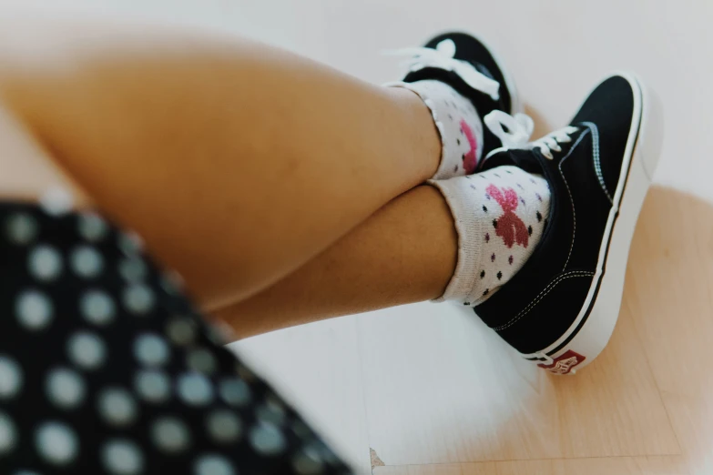 the legs and shoes of a person wearing a dress and shoes