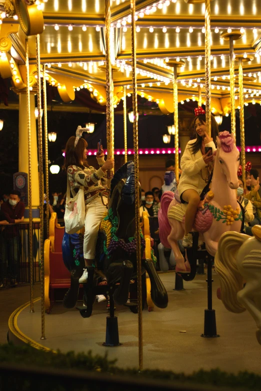 there is some horses on a carousel that is all colorful