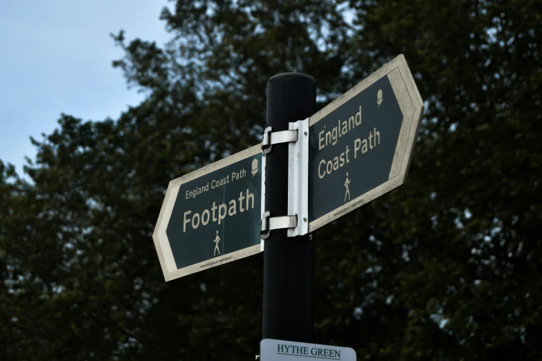 the two street signs are indicating directions to different towns