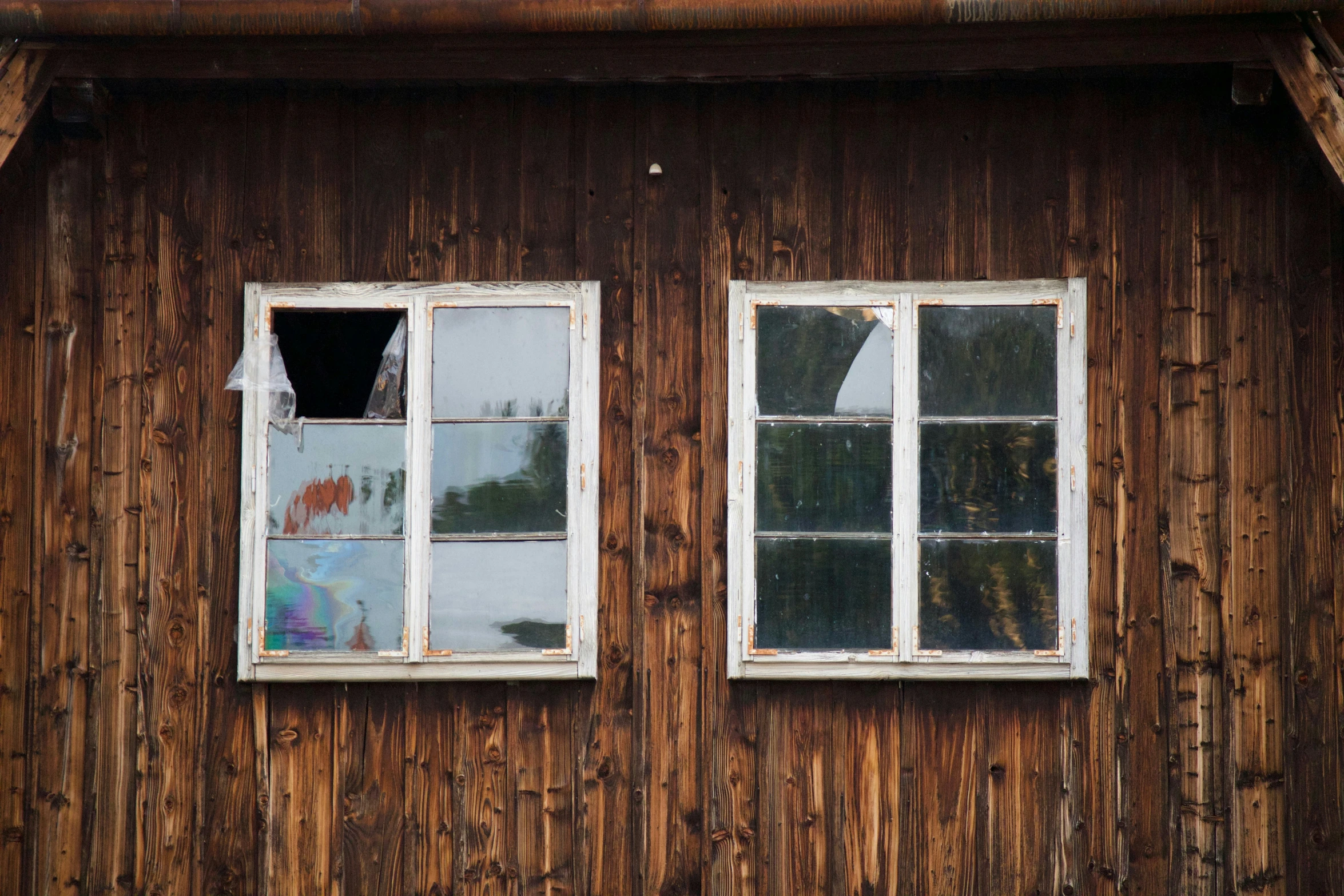 a boarded up window inside of a wood structure