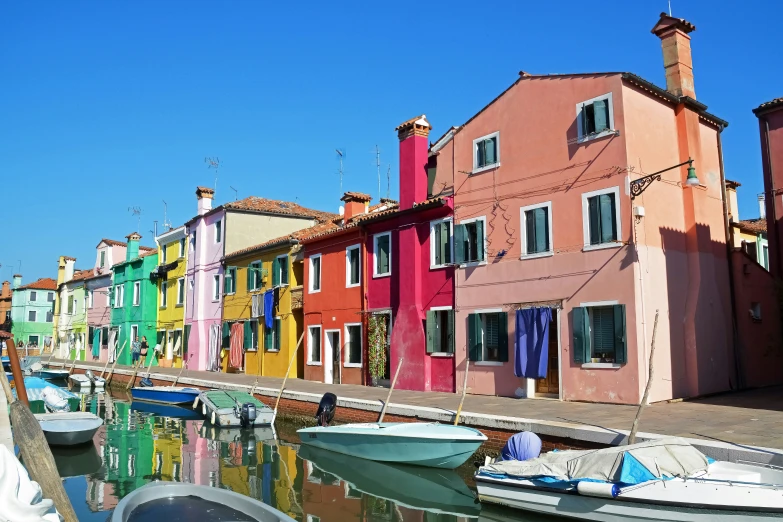 a line of colorful houses on a waterway