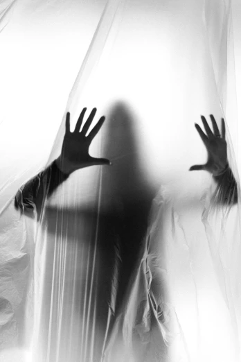 shadow of a person covering their face and hand