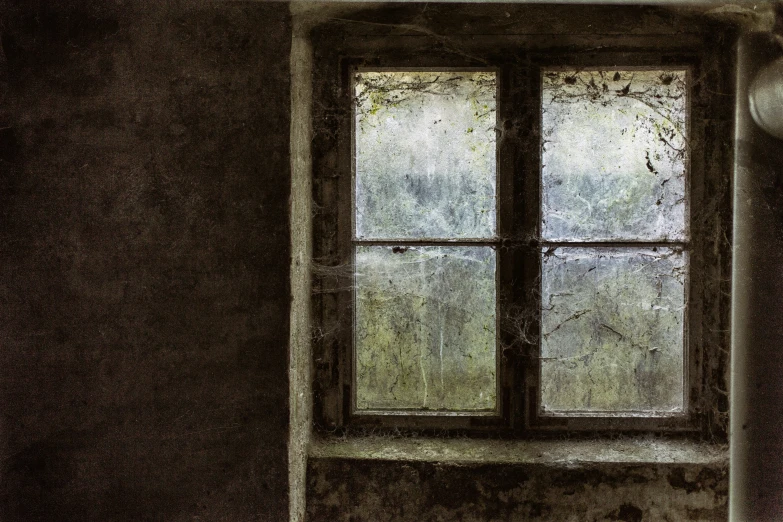 a window with a rusty frame next to a rusted wall