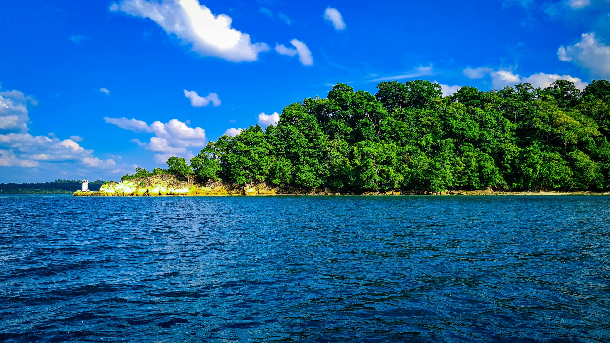 a body of water with a large hill in the background