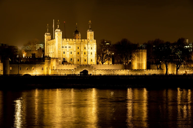 a beautiful castle is lit up on a dark night