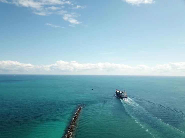 a ship sailing in the open water by a dock