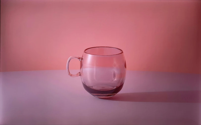 a clear glass mug sitting on top of a table