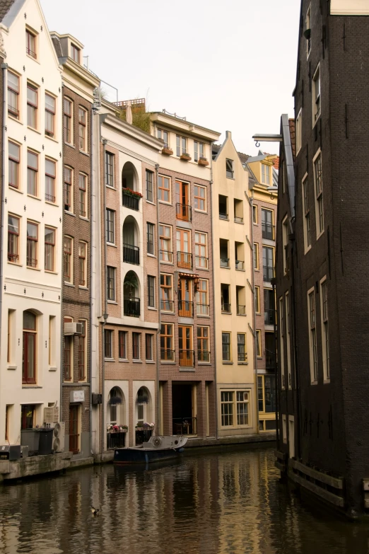 a row of old buildings are near the water