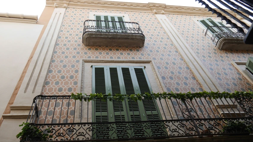 a balcony with window boxes on it next to a building