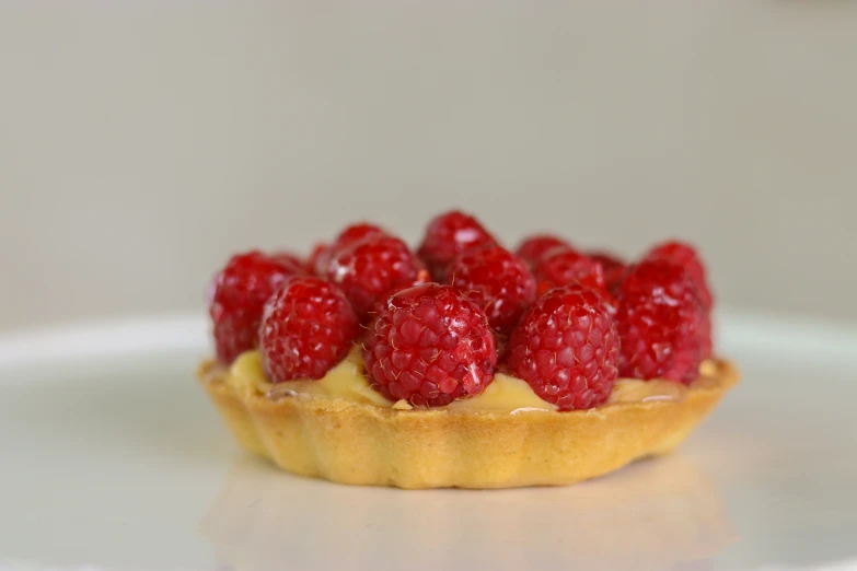 some raspberries are on top of a pastry