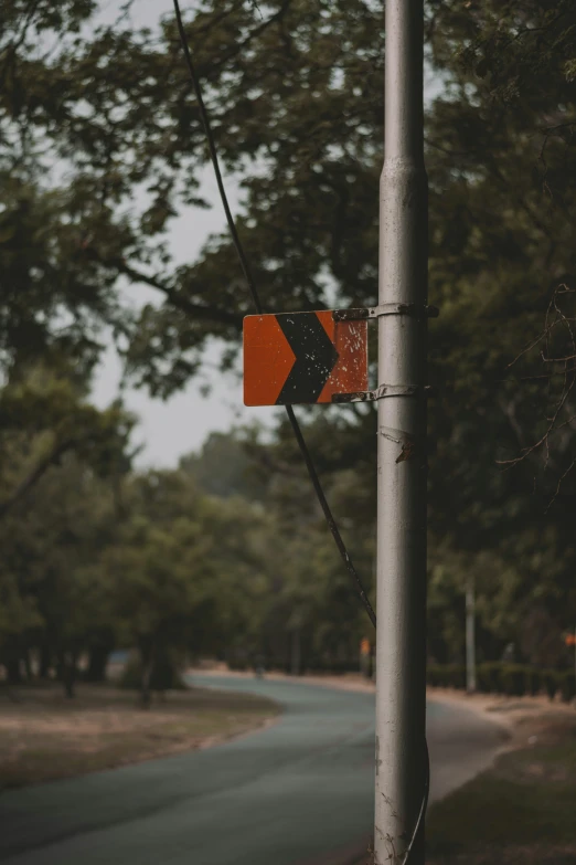 the traffic sign is pointing to a left lane