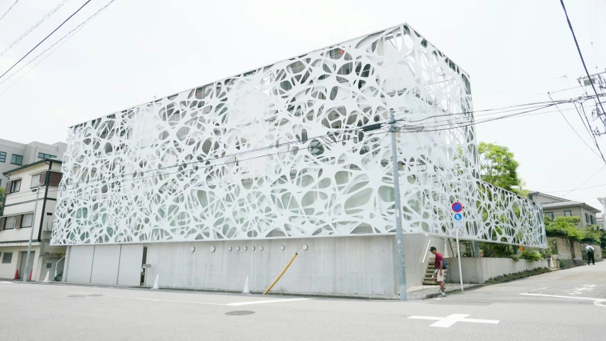 a large white building is on a corner and people are standing outside it