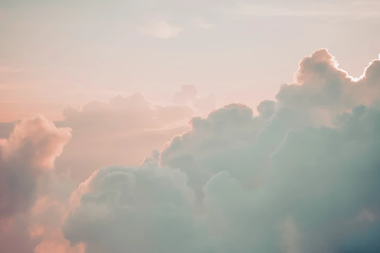 a view through some fluffy clouds during sunset