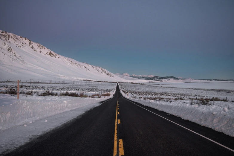 a long stretch of open road covered in snow