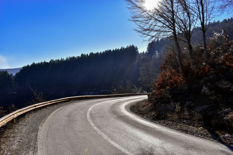 a winding winding road with trees in the background