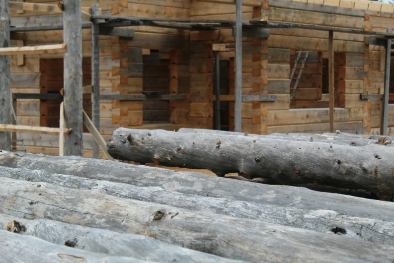 wooden planks on the ground and a building in the background