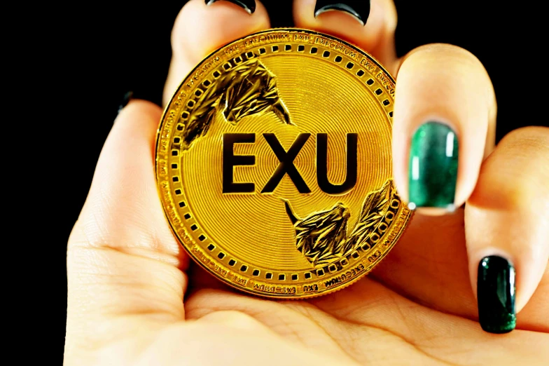 a person holding up a gold plate with a name plate