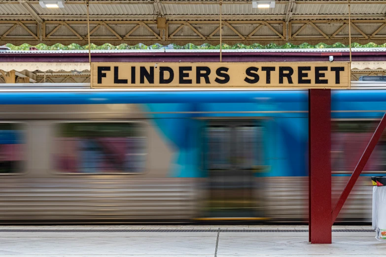 a blurry pograph of a train moving through the station