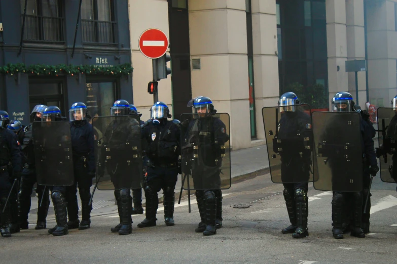 a row of police standing in the street