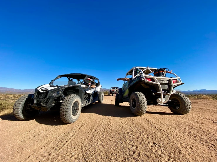 two big wheels that are sitting on some dirt