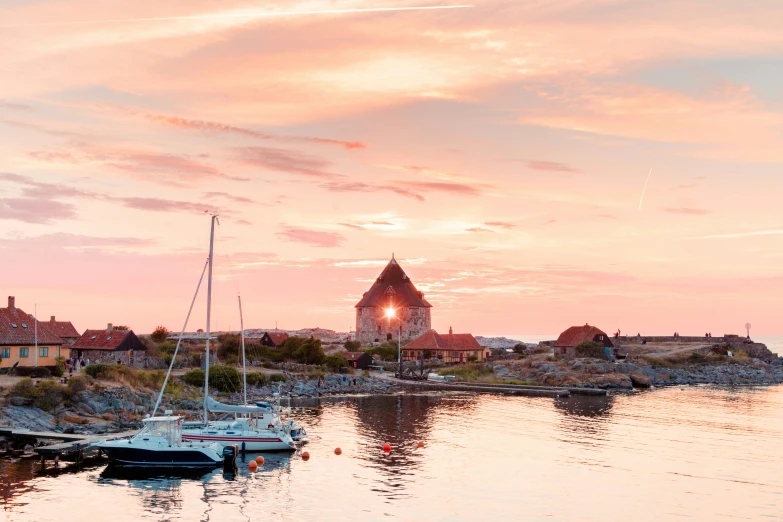 two small sailboats floating on a body of water