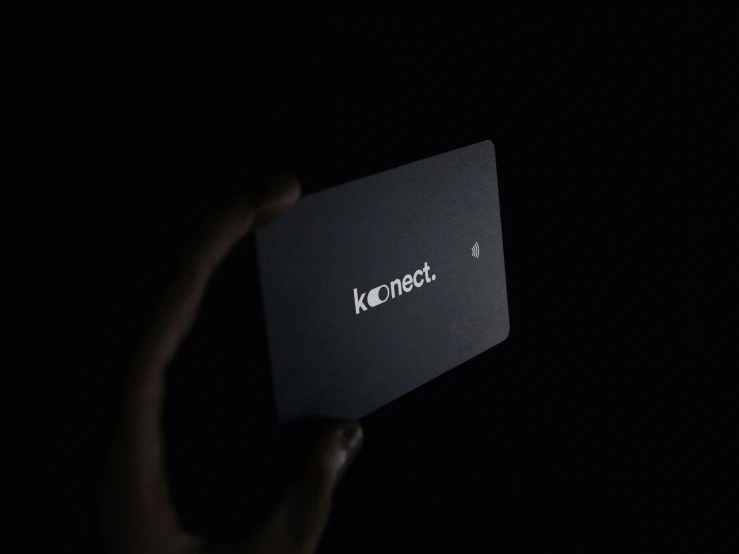 a hand is holding a card with the word kinredet in it