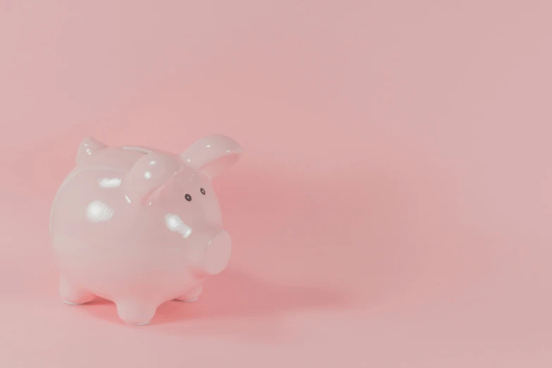 a white plastic pig toy sitting on a pink surface