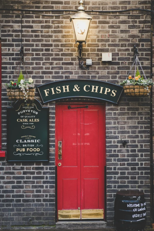 a restaurant that has a brick facade and a red door