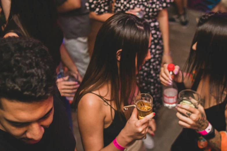 group of people standing around drinking and having drinks