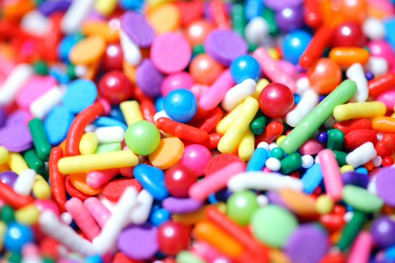 a pile of candy beans with different colors and sizes