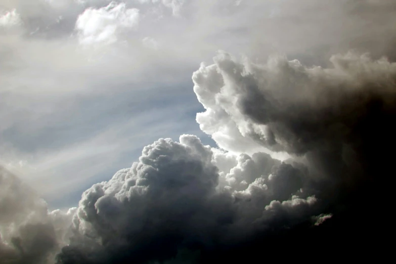 the dark storm clouds are towering above the city