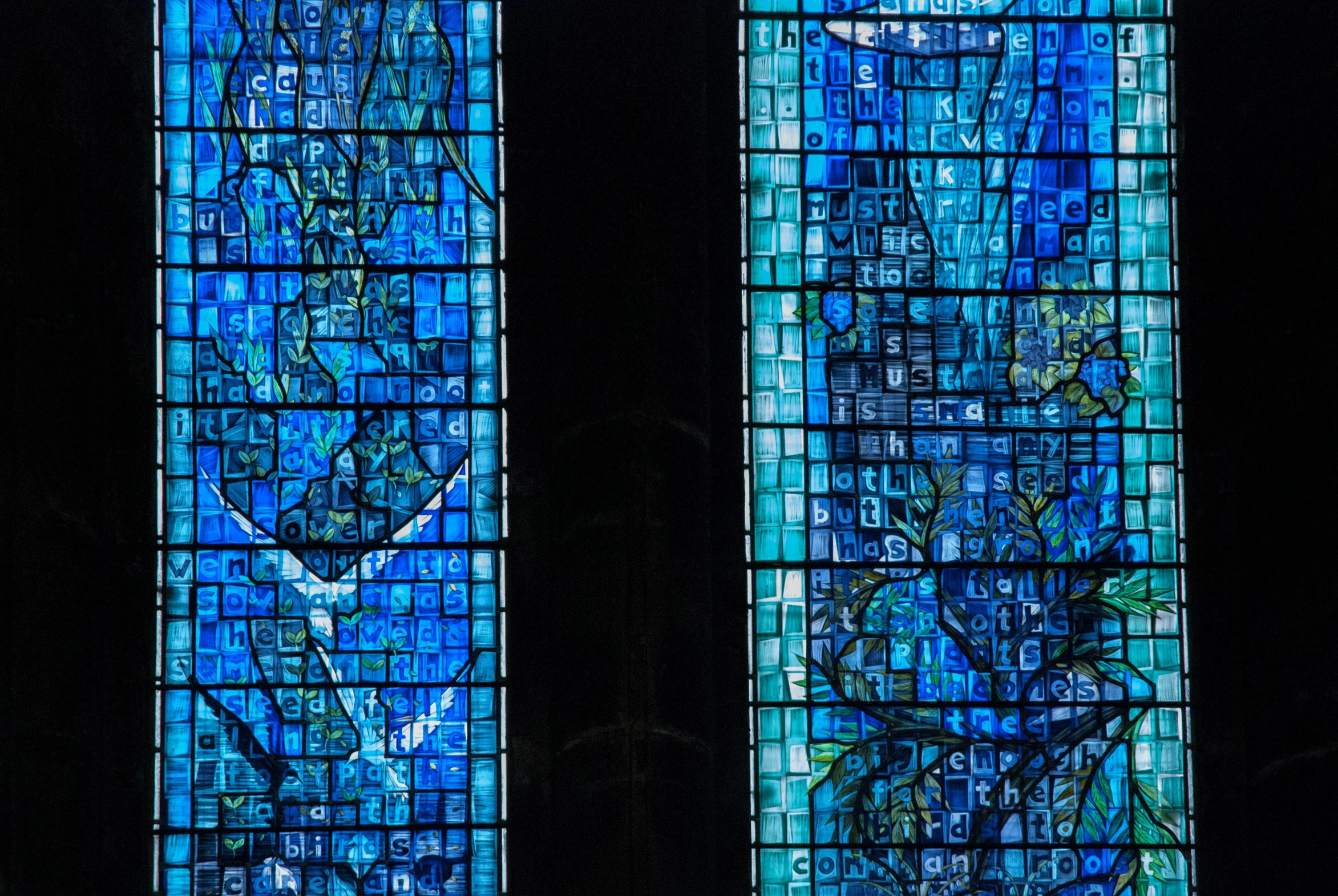 two very large stained glass windows with blue paint