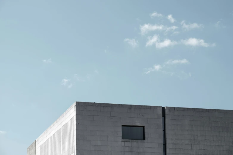 the airplane is flying by the building and windows