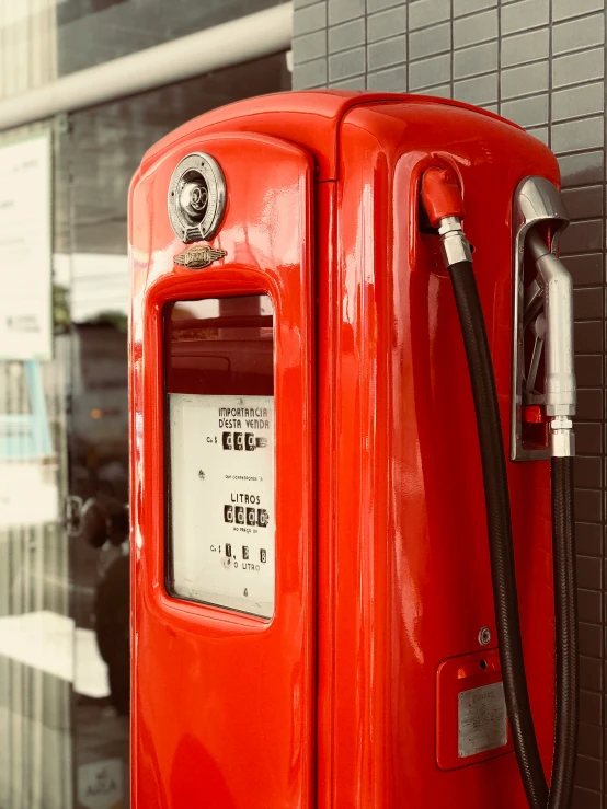 red gas pump located in front of a building