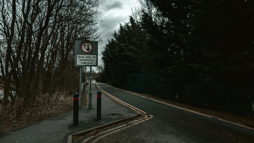 a street sign is standing on the side of a road