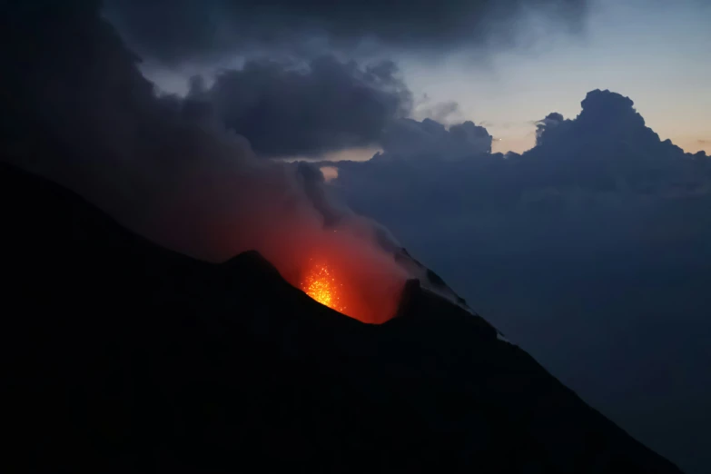 a volcano with a bright orange lava below