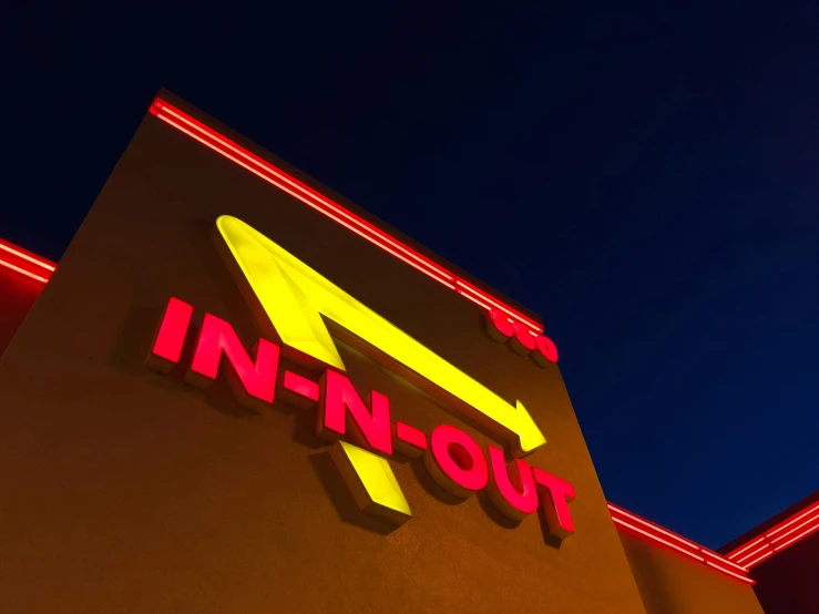 a neon sign lit up for an in - n - out