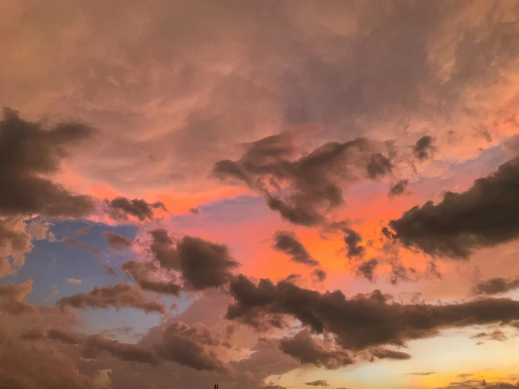 a view of the sky with clouds and a lighthouse in front of it