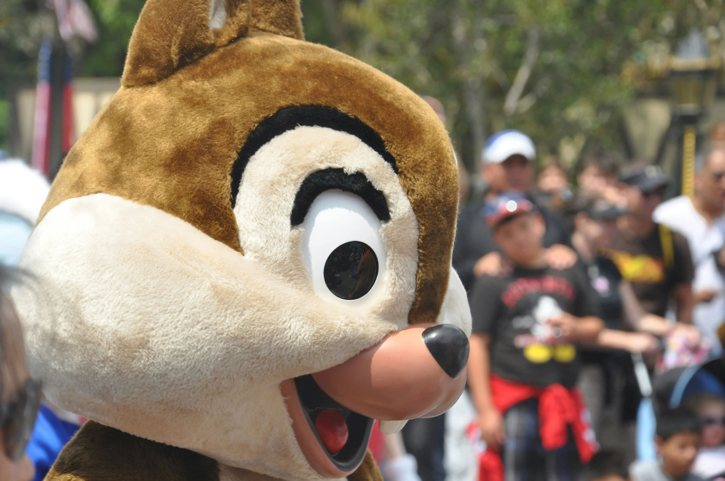 a close up of a mascot and others watching