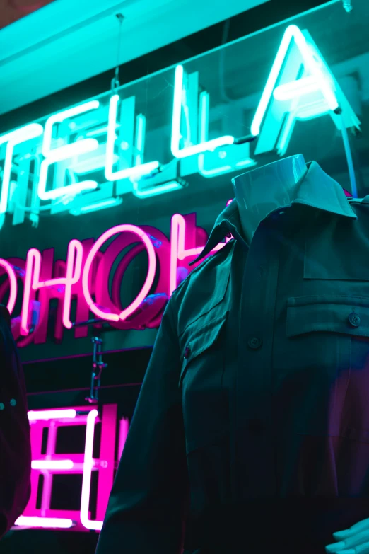 neon signage over a dark jacket mannequin's head