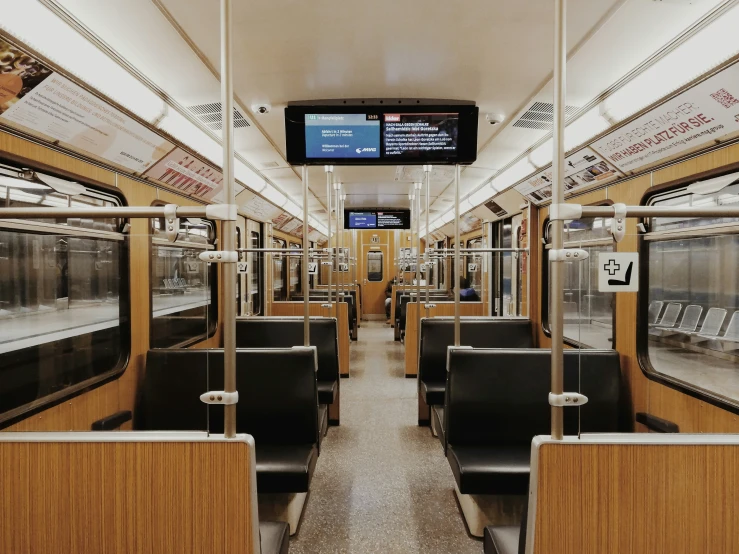 the inside of a public transportation train with many empty seats