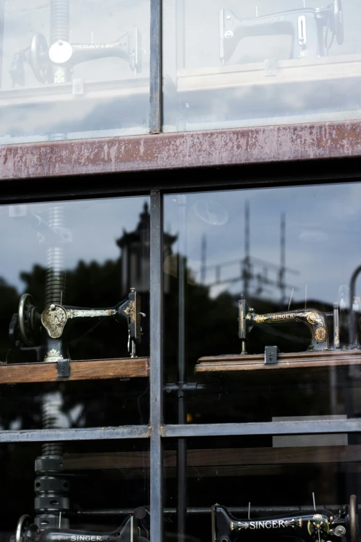 the reflection of sewing machines in the windows