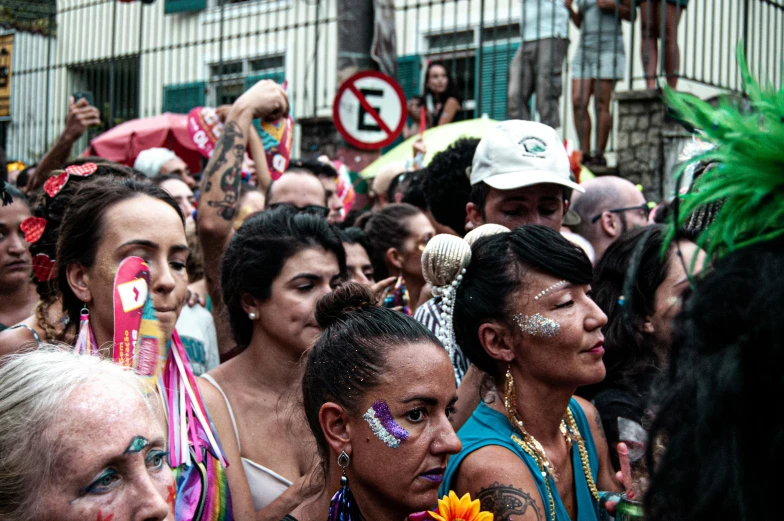 a crowd of people with faces painted on