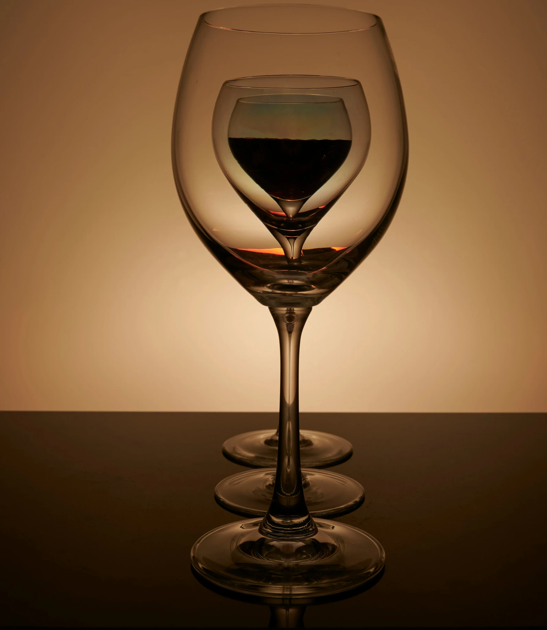 three wine glasses with wine sitting on a table