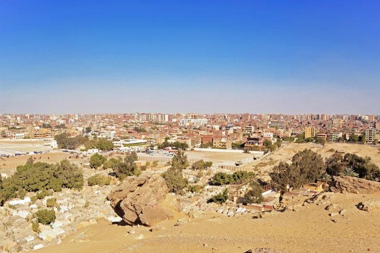 the city is in the distance, and the land looks quite barren